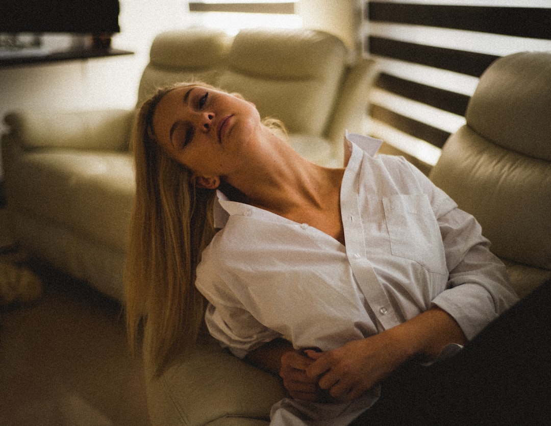 a woman laying on a couch in a living room